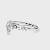 White gold Pear Cut Diamond Ring with Baguette Side Stones, Channel Set Band, and Four-Prong Setting