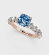 Rose gold Fancy Blue Cushion Cut Diamond Prong Setting with Side Stones on a Pave Band