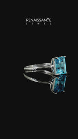 Silver Emerald Cut Blue Topaz Solitaire Engagement Ring with Round Band and Four-Prong Setting