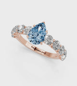 Rose gold Fancy Blue Pear Cut Diamond Prong Setting with Side Stones on a Pave Band
