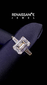 Yellow gold Emerald Solitaire with Tapered Baguette Side Stones on a Classic Band with Four-Prong Setting