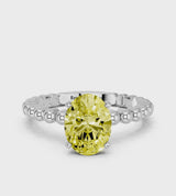 Platinum Fancy Yellow Oval Cut Diamond Solitaire Ring with Beaded Band and Prong Setting