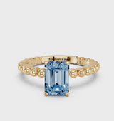 Yellow gold Fancy Blue Emerald Cut Diamond Solitaire Ring with Beaded Band and Prong Setting