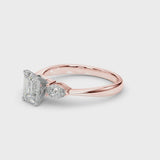 Rose gold Three-Stone Emerald Cut Diamond Ring with Pear Side Stones and Four-Prong Setting