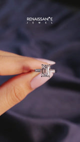 Silver Emerald Cut Diamond Solitaire Ring with Tapered Baguette Accents and Four-Prong Setting