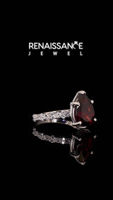 Silver Pear Cut Garnet Side Stone Solitaire Ring with Round and Four-Prong Setting