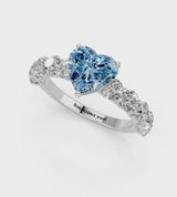 White gold Fancy Blue Heart Cut Diamond Prong Setting with Side Stones on a Pave Band
