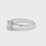 Platinum Emerald Solitaire Engagement Ring with Four-Prong Setting and Tapered Band
