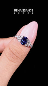 Silver Oval Cut Blue Sapphire Ring with Side Stones and Four-Prong Setting