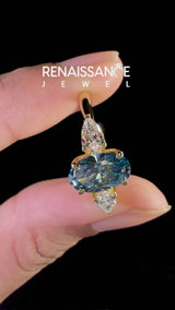 Yellow gold Fancy Blue Oval Cut Diamond Three-Stone Ring with Pear Side Stones and Prong Setting