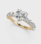 Yellow gold Heart Cut Diamond Prong Setting with Side Stones on a Pave Band