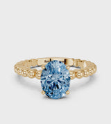 Yellow gold Fancy Blue Oval Cut Diamond Solitaire Ring with Beaded Band and Prong Setting