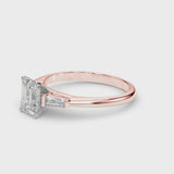 Rose gold Emerald Solitaire with Tapered Baguette Side Stones on a Classic Band with Four-Prong Setting