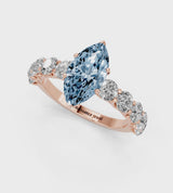 Rose gold Fancy Blue Marquise Cut Diamond Prong Setting with Side Stones on a Pave Band