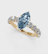 Yellow gold Fancy Blue Marquise Cut Diamond Prong Setting with Side Stones on a Pave Band