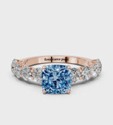 Rose gold Fancy Blue Cushion Cut Diamond Prong Setting with Side Stones on a Pave Band