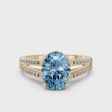 Yellow gold Fancy Blue Oval Cut Diamond Solitaire Engagement Ring with Split Shank Pavé Band