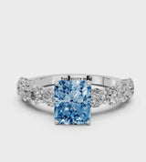 White gold Fancy Blue Radiant Cut Diamond Prong Setting with Side Stones on a Pave Band