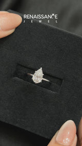 Platinum Pear Cut Diamond Solitaire Engagement Ring with Round Band and Four-Prong Setting