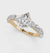 Yellow gold Pear Cut Diamond Prong Setting with Side Stones on a Pave Band
