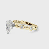 Yellow gold Pear Solitaire Bezel-Set Diamond Ring with Beaded Band and Four-Prong Setting