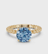 Yellow gold Fancy Blue Round Cut Diamond Solitaire Ring with Beaded Band and Prong Setting