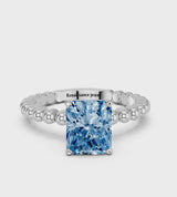White gold Fancy Blue Radiant Cut Diamond Solitaire Ring with Beaded Band and Prong Setting