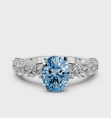 White gold Fancy Blue Oval Cut Diamond Prong Setting with Side Stones on a Pave Band