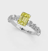 White gold Fancy Yellow Emerald Cut Diamond Prong Setting with Side Stones on a Pave Band