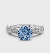 White gold Fancy Blue Round Cut Diamond Prong Setting with Side Stones on a Pave Band