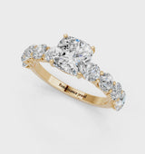 Yellow gold Cushion Cut Diamond Prong Setting with Side Stones on a Pave Band