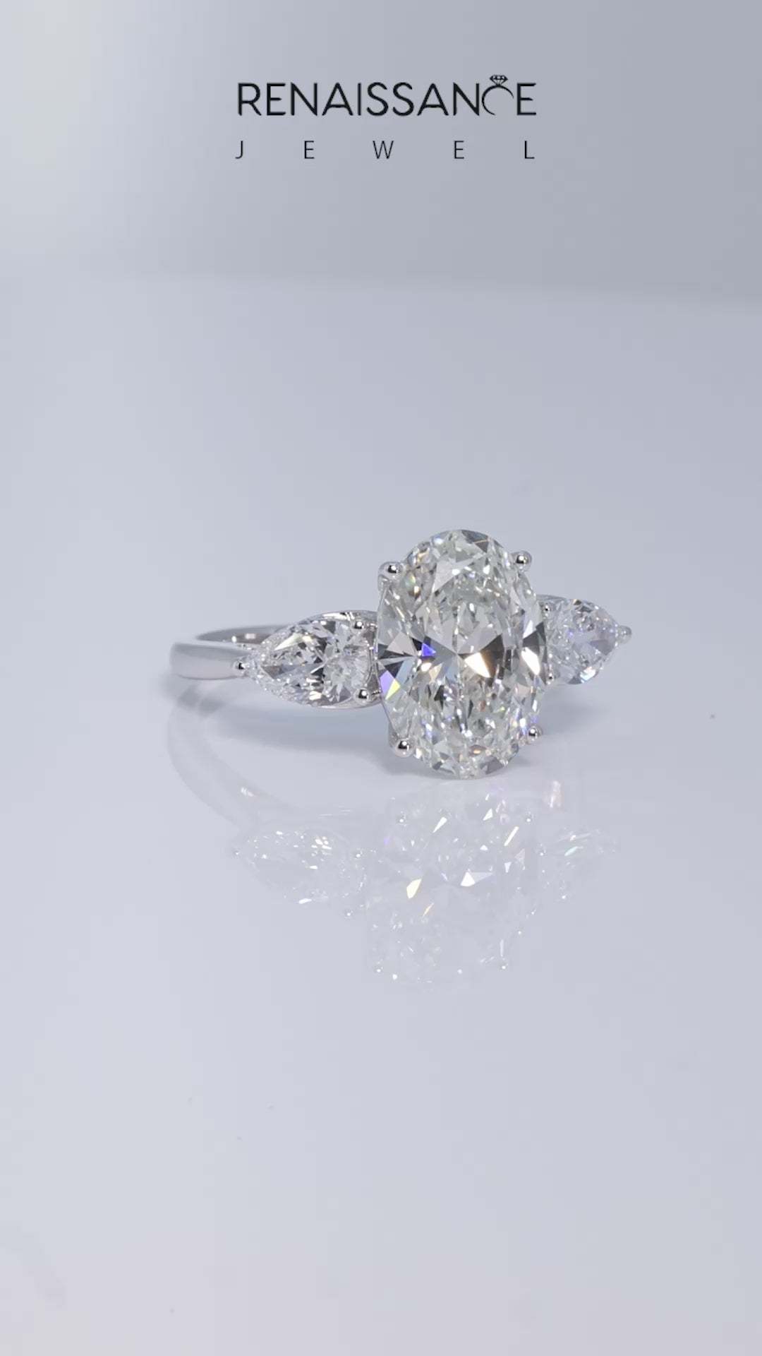 White gold Three-Stone Oval Diamond Solitaire Ring with Pear Side Stones and Four-Prong Setting_25