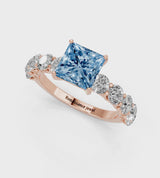 Rose gold Fancy Blue Princess Cut Diamond Prong Setting with Side Stones on a Pave Band