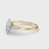 Yellow gold Marquise Solitaire with Tapered Baguette Side Stones on a Classic Band with Four-Prong Setting