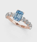 Rose gold Fancy Blue Emerald Cut Diamond Prong Setting with Side Stones on a Pave Band