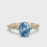Yellow gold Fancy Blue Oval Cut Solitaire Diamond Ring with Pave Band and Four-Prong Setting
