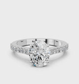 Platinum Oval Cut Solitaire Diamond Engagement Ring with Pave Band and Four-Prong Setting