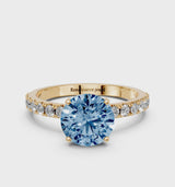 Yellow gold Fancy Blue Round Cut Diamond Solitaire Pavé Band with Four-Prong Setting