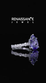Silver Pear Cut Tanzanite Side Stone Solitaire Ring with Round and Four-Prong Setting