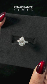 Platinum Pear Solitaire with Tapered Baguette Side Stones on a Classic Band with Four-Prong Setting