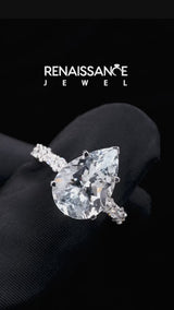 Silver Pear Cut Aquamarine Side Stone Solitaire Ring with Round and Four-Prong Setting