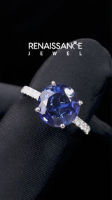 Silver Round Cut Blue Sapphire Solitaire Ring with Round  Pavé Band and Four-Prong Setting