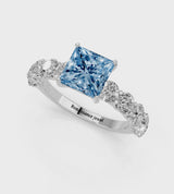 Platinum Fancy Blue Princess Cut Diamond Prong Setting with Side Stones on a Pave Band