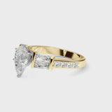 Yellow gold Pear Cut Diamond Engagement Ring with Baguette Side Stones and Channel Set Band