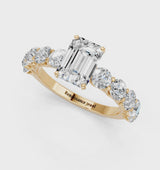 Yellow gold Emerald Cut Diamond Prong Setting with Side Stones on a Pave Band