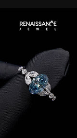 Silver Fancy Blue Oval Cut Diamond Solitaire Ring with Side Stones and Four-Prong Setting