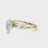 Yellow gold Pear Cut Diamond Ring with Baguette Side Stones, Channel Set Band, and Four-Prong Setting