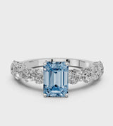 White gold Fancy Blue Emerald Cut Diamond Prong Setting with Side Stones on a Pave Band