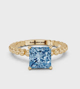 Yellow gold Fancy Blue Princess Cut Diamond Solitaire Ring with Beaded Band and Prong Setting