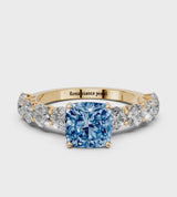 Yellow gold Fancy Blue Cushion Cut Diamond Prong Setting with Side Stones on a Pave Band